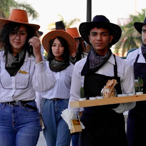 LOriental waiters dressed as cowboys